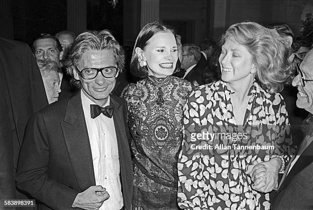Portrait of American fashion photographer Richard Avedon, with Gloria Vanderbilt and Suzy Parker, at the opening of Avedon's exhibit at the...