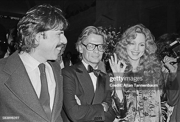 Artist Peter Max and fashion photographer Richard Avedon, with an unidentified woman, at the opening of Avedon's exhibit at the Metropolitan Museum...