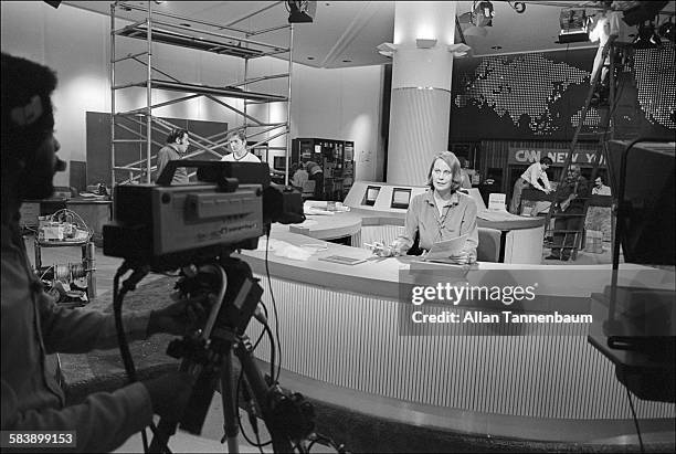 Anchorwoman Mary Alice Williams broadcasts from new cable TV news network CNN's studio, during set construction in the World Trade Center lobby, New...
