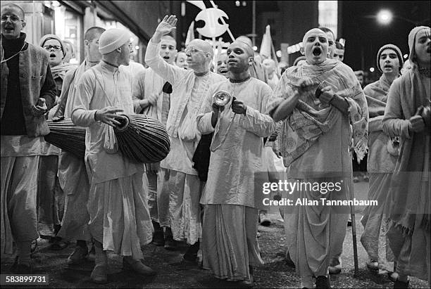 At night, Hare Krishna devotees chant in Times Square, New York, New York, October 10, 1976.