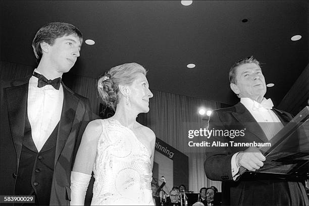 President Ronald Reagan speaks at an Inaugural Ball as his son, Ron Jr, and wife, First Lady Nancy Reagan watch, Washington DC, January 20, 1981.