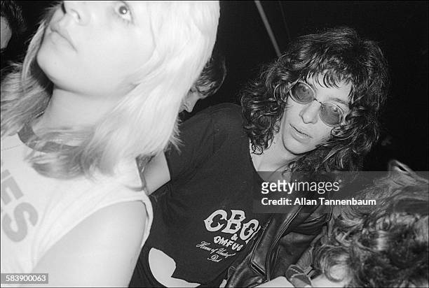 American musician Joey Ramone, of the group the Ramones, in a CBGB t-shirt as he stands outside the club after a gig, New York, New York, October 30,...
