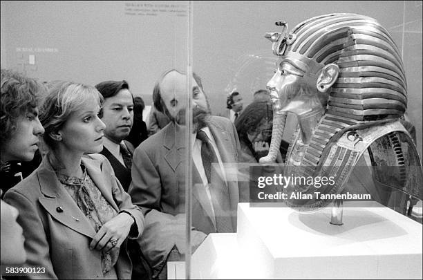 View of people as they look at a mask at the King Tut exhibit in Metropolitan Museum of Art, New York, New York, December 11, 1978.