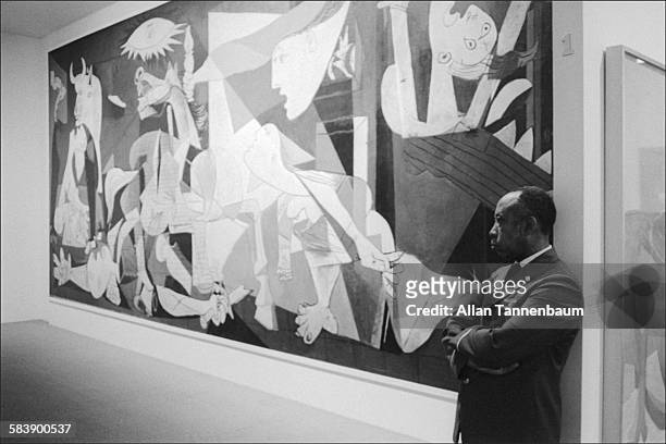 At the Museum of Modern Art, a guard stands watch over Picasso's 'Guernica', New York, New York, February 2, 1975. Less than a year earlier, the...