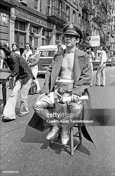 Japanese performance artist Minoru Yoshida sits on a stool in the middle of a SoHo street as he prepares for his 'Flight' performance, New York, New...