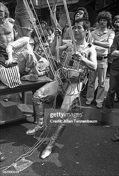 Japanese performance artist Minoru Yoshida prepares to launch himself, via an elaborate system of ropes, from West Broadway, New York, New York, May...