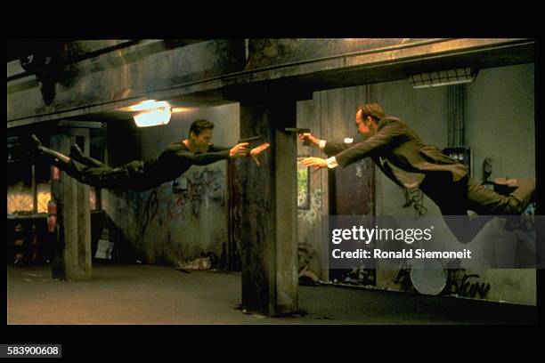 Keanu Reeves and Hugo Weaving face each other in a scene from Andy and Larry Wachowski's 1999 movie The Matrix. In this scene, Neo fights the...
