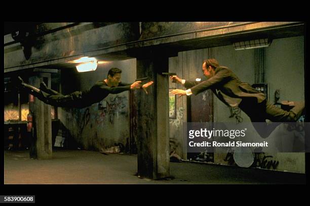 Keanu Reeves and Hugo Weaving face each other in a scene from Andy and Larry Wachowski's 1999 movie The Matrix. In this scene, Neo fights the...