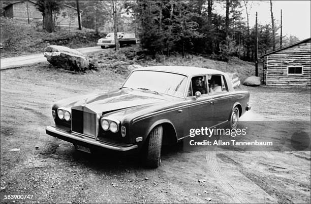 In his Rolls Royce, American heavyweight boxer Muhammad Ali drives his family to his training camp, Deer Lake, Pennsylvania, September 22, 1977.