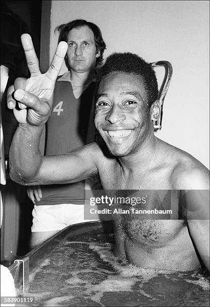 Brazilian soccer player Pele, of the New York Cosmos, gives a v for victory sign as he sits in a whirlpool in the locker room after a game, New York,...