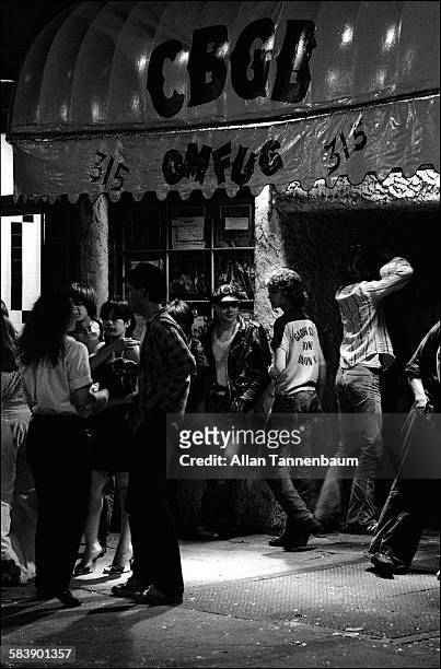 View of people outside the entrance to CBGB on the Bowery, New York, New York, May 27, 1977.