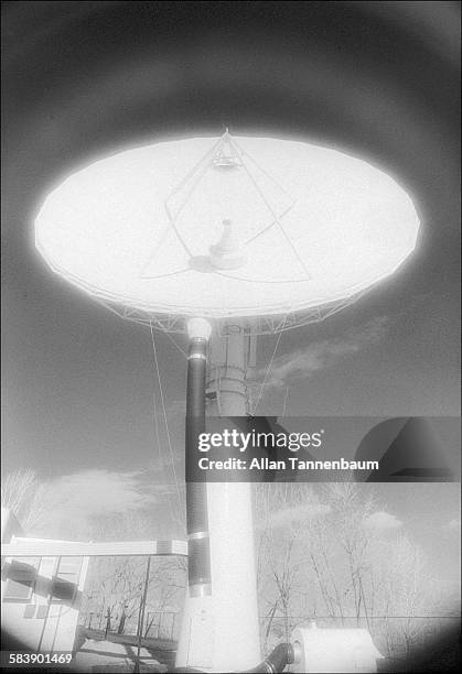 Americom Satellite Link Antenna, used to send and receive cable TV images, seems to glow and send wave with infrared photography, New York, February...