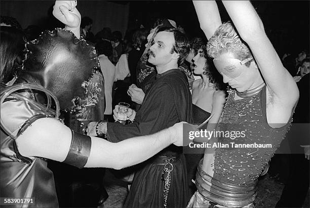 Two clubgoers, dressed in makeshift fetish gear, dance at the first Halloween party at Studio 54, New York, New York, October 31, 1977.