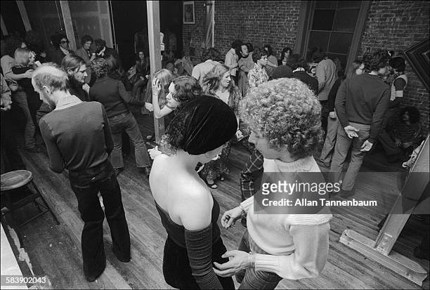 Elevated view of dancers at a loft party in SoHo, New York, New York, January 9, 1974. A bodega is in the background.