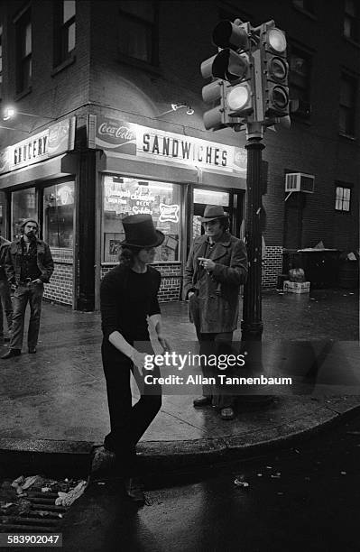 Street mime performs at the corner of West Broadway and Prince Street in SoHo, New York, New York, January 15, 1975. A bodega is in the background.