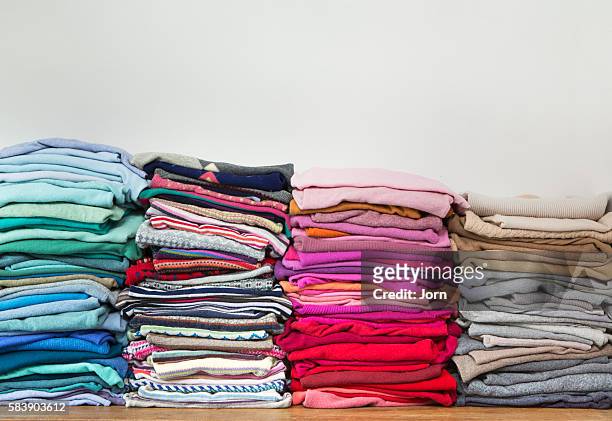 pile of clothes - ropa fotografías e imágenes de stock