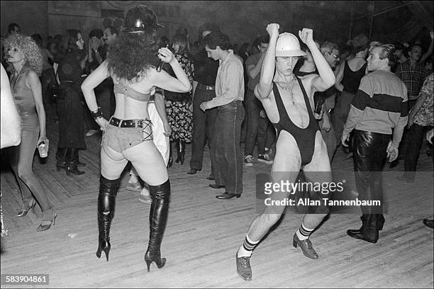 Costumed party goers dance during a Construction Party at Bonds' in Times Square, New York, New York, April 3, 1980.