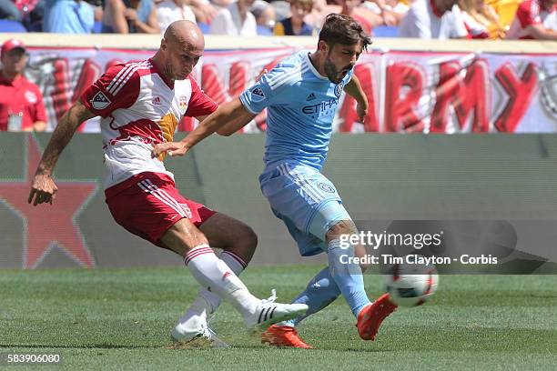 Aurelien Collin of New York Red Bulls clears the ball from David Villa of New York City FC during the New York Red Bulls Vs New York City FC MLS...