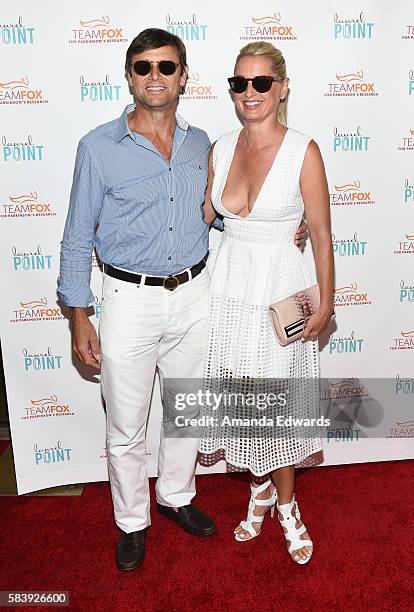 Actor Grant Show and actress Katherine LaNasa arrive at the Raising The Bar To End Parkinson's event at Laurel Point on July 27, 2016 in Studio City,...