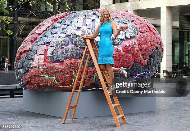 Television presenter Rachel Riley places the final home-grown strawberries on top of a giantmodel brain on July 28, 2016 in London, United Kingdom.