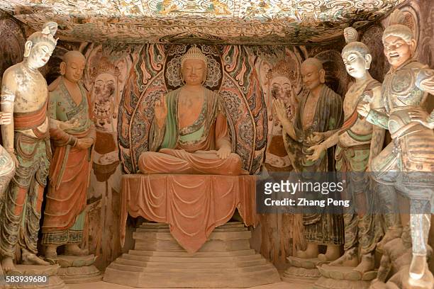 Buddha statues in the replica of cave 45 , exhibited in Dunhuang Museum. The Mogao Caves, also known as the Thousand Buddha Grottoes, are the best...