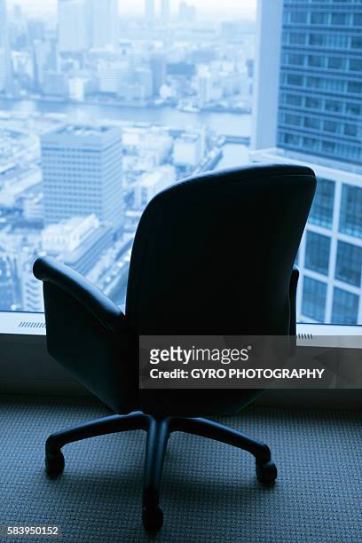 chair beside window - office chair back fotografías e imágenes de stock
