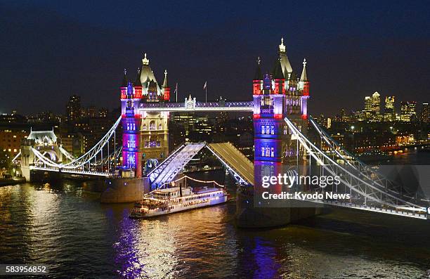 Britain - An illumination of red, blue and white, the colors of the Union Jack, begins on a trial basis at the London Tower Bridge in the British...