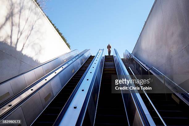 escalator going up - escalator stock-fotos und bilder