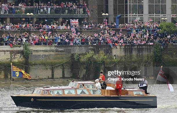 Britain - A boat carrying Queen Elizabeth II travels down the River Thames in London on June 3 in a pageant celebrating 60 years since her...