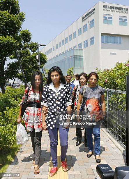 Japan - Radha Mainali and her daughters Mithila and Alisha leave the Tokyo Regional Immigration Bureau's Yokohama office on June 8 after meeting...