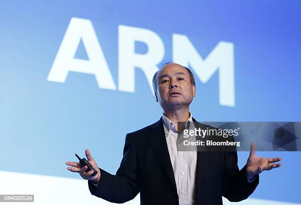 Billionaire Masayoshi Son, chairman and chief executive officer of SoftBank Group Corp., speaks in front of a screen displaying the ARM Holdings Plc...