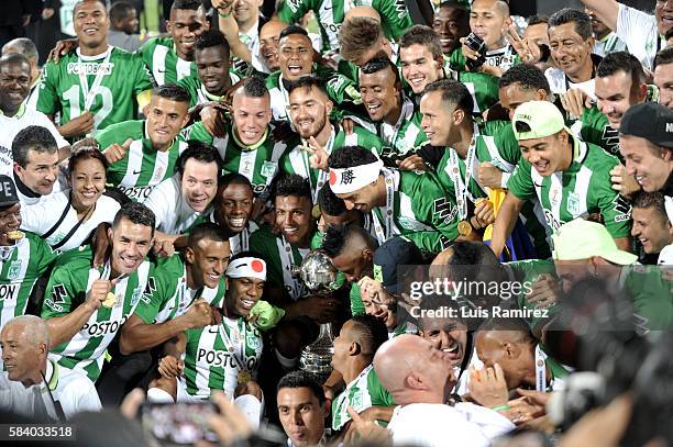 Players of Nacional celebrate with the trophy to celebrate as champions of the Copa Libertadores 2016 after a second leg final match between Atletico...