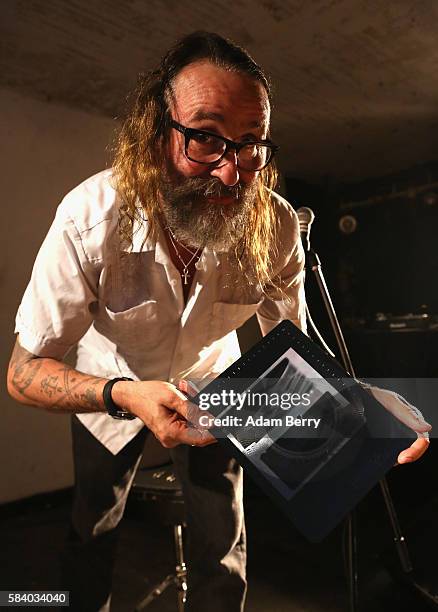 Alexander Hacke, bassist and former guitarist for German industrial/experimental band Einstuerzende Neubauten, shows an x-ray vinyl recording of his...