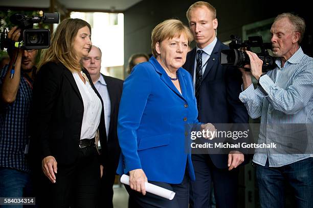 German Chancellor Angela Merkel leaves her annual summer press conference in German Federal Press Conference or Bundespressekonferenz on July 28,...