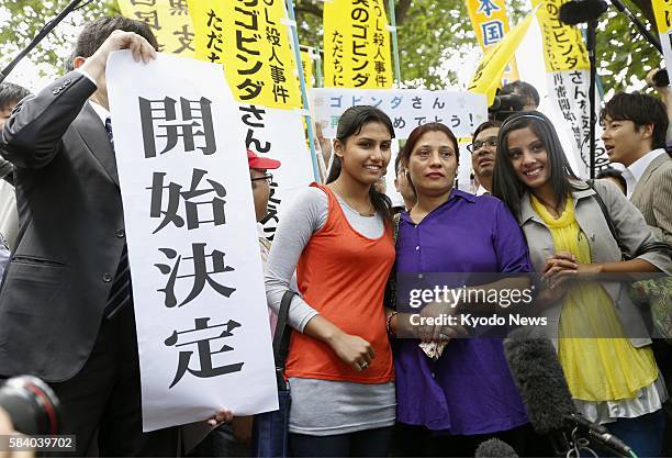 Japan - Radha Mainali and her eldest daughter Mithila and second daughter Alisha pose for photos in front of the Tokyo High Court on June 7 after...