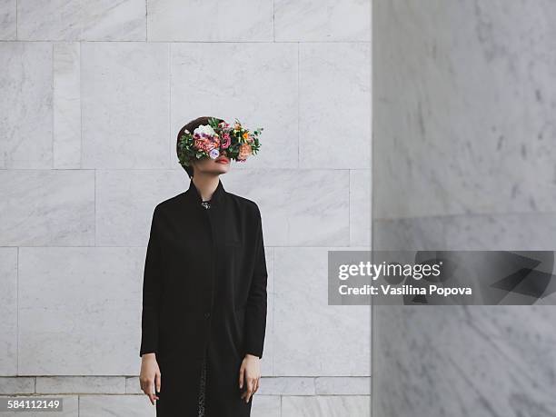 woman with floral glasses - obscured face ストックフォトと画像