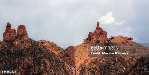 charyn canyon rock formation and group of trekkers - kazakhstan steppe stock pictures, royalty-free photos & images