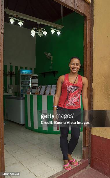Young woman on the door of her shop