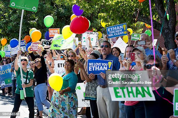 Fans and supporters wave as 6-year-old Ethan Dean, who was diagnosed with cystic fibrosis at two weeks old, arrives in front of the Sacramento Bee in...