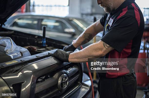 Mechanic works on a truck inside a Chevron Corp. Gas station in Albuquerque, New Mexico, U.S., on Tuesday, July 26, 2016. Chevron is scheduled to...