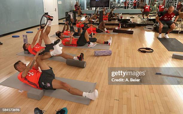 Rafinha, Nicolas Feldhahn, goalkeeper Sven Ulreich, Thiago, David Alaba and Xabi Alonso of Bayern Muenchen stretch at the gym during a training...