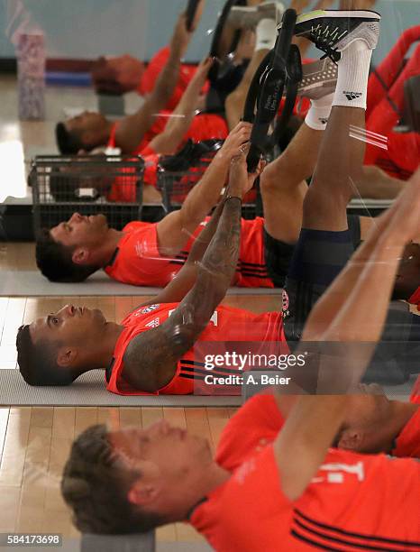 Thiago, Nicolas Feldhahn and Xabi Alonso of Bayern Muenchen stretch at the gym during a training session during the AUDI Summer Tour USA 2016 on July...