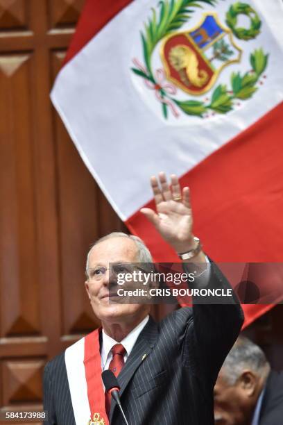 Pedro Pablo Kuczynski waves at the end of his speech after swearing in as Perus President, at the National Congress building in Lima on July 2016. -...