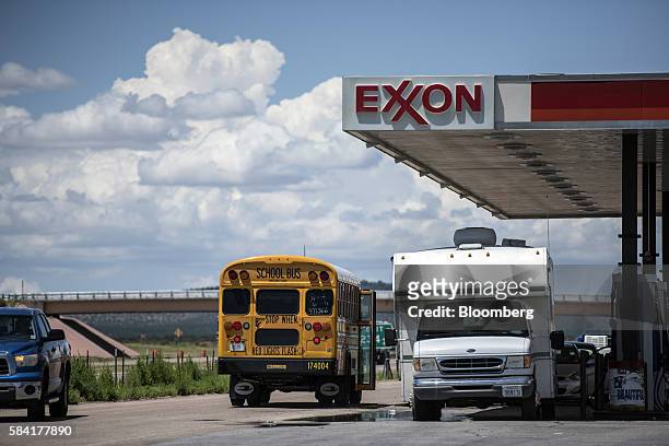 School bus stops next to a roadside Exxon gas station outside Aurora, New Mexico, U.S., on Tuesday, July 26, 2016. Exxon Mobil Corp. Is scheduled to...