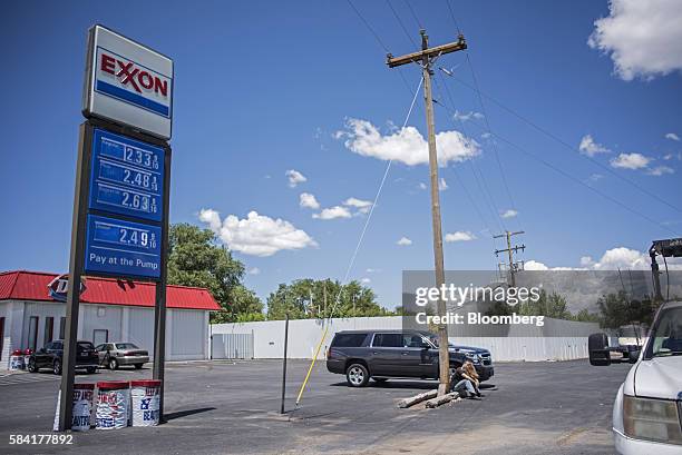 An Exxon sign displays gas prices at a roadside station outside Aurora, New Mexico, U.S., on Tuesday, July 26, 2016. Exxon Mobil Corp. Is scheduled...