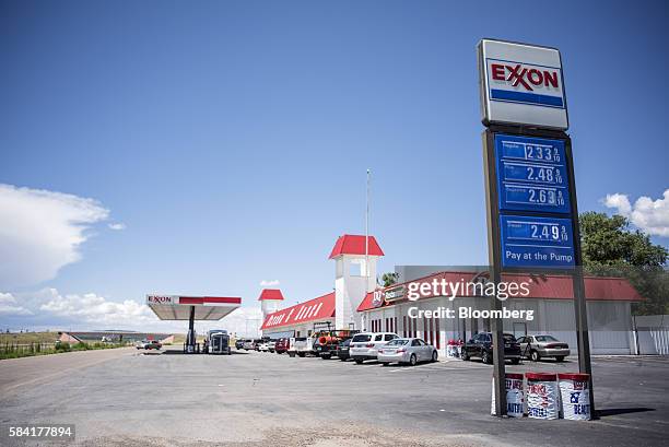 An Exxon sign displays gas prices at a roadside station outside Aurora, New Mexico, U.S., on Tuesday, July 26, 2016. Exxon Mobil Corp. Is scheduled...