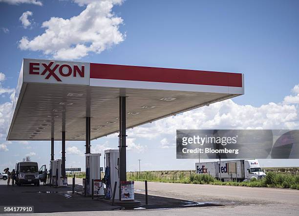 FedEx Corp. Truck drives past a roadside Exxon Corp. Gas station outside Aurora, New Mexico, U.S., on Tuesday, July 26, 2016. Exxon Mobil Corp. Is...