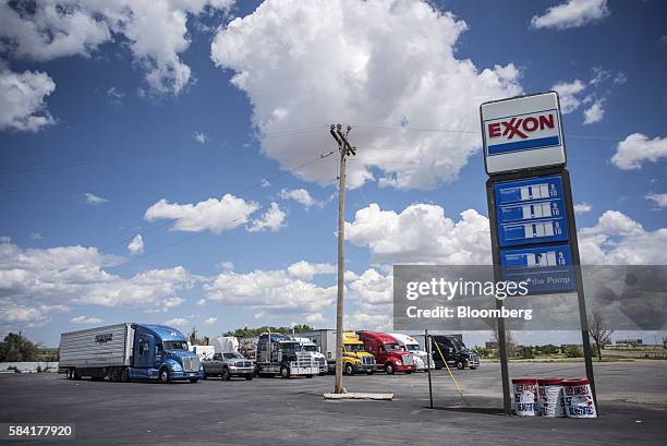 Semi trucks are parked behind a roadside Exxon station outside Aurora, New Mexico, U.S., on Tuesday, July 26, 2016. Exxon Mobil Corp. Is scheduled to...