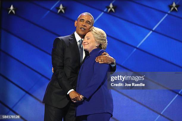 President Barack Obama and Democratic presidential candidate Hillary Clinton embrace on the third day of the Democratic National Convention at the...