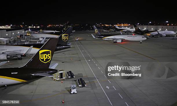 Cargo jets are unloaded on the tarmac during the night package sort at the United Parcel Service Inc. Worldport facility in Louisville, Kentucky,...